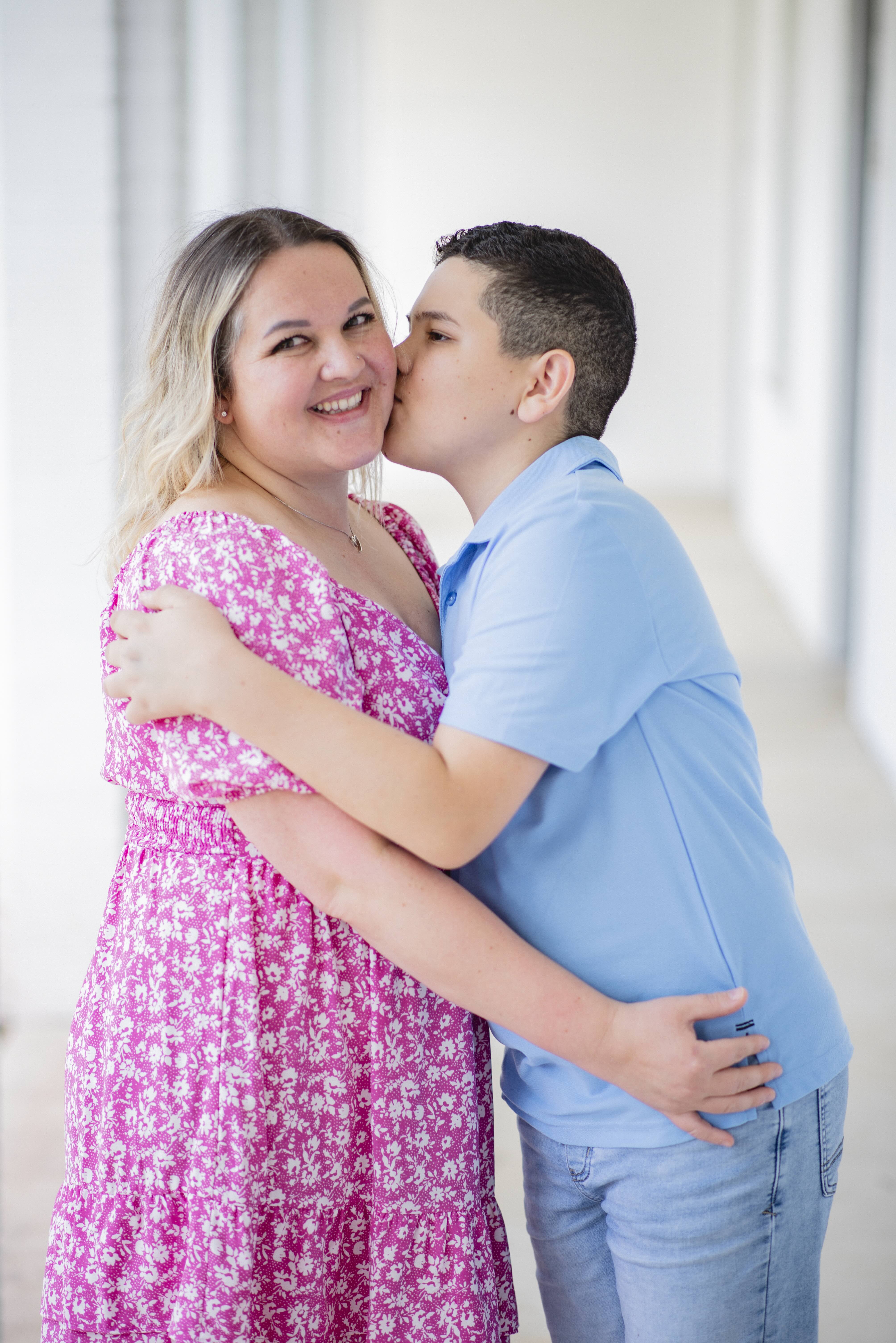 Mother and son kissing cheek